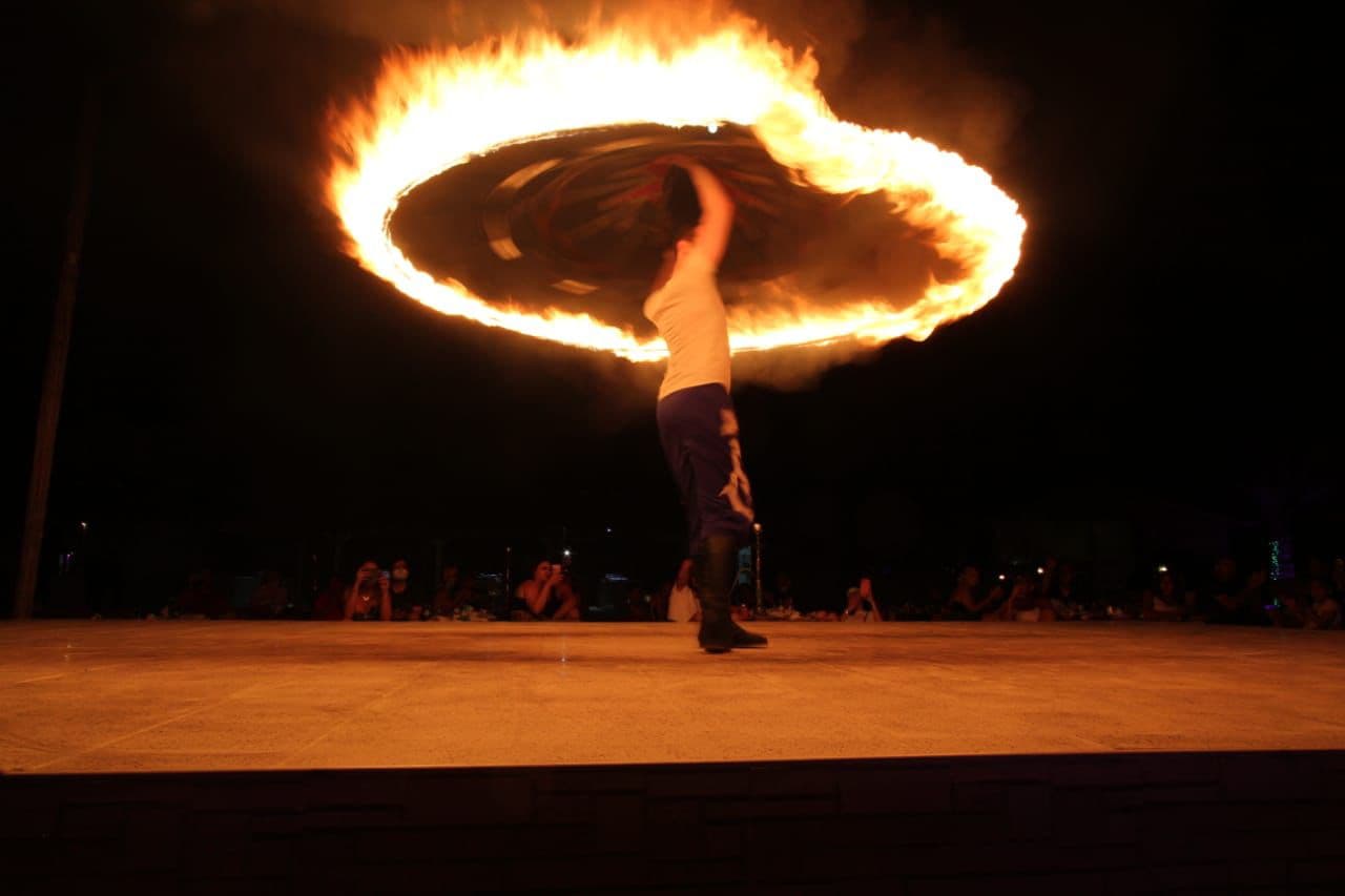 Fire performer with flaming torches